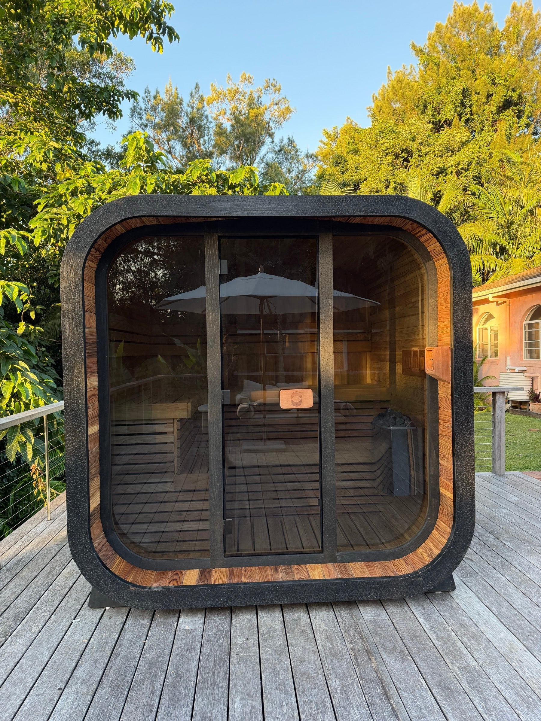 Psycle Wellness Genesis sauna charcoal Shou Sugi Ban exterior cedar interior glowing amber golden hour foliage deck Australia