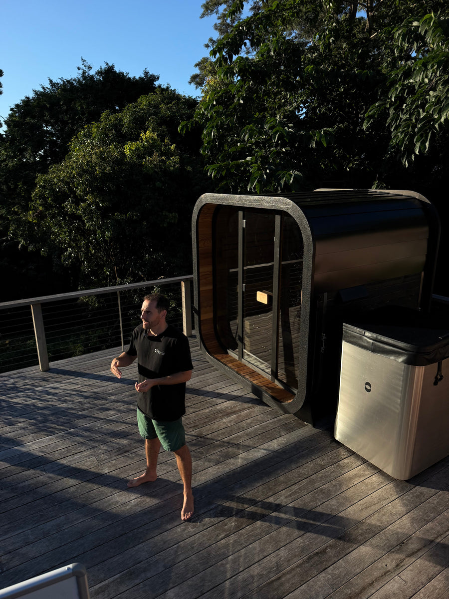 Man entering Psycle Origin ice bath cold plunge Genesis sauna background outdoor deck Australia